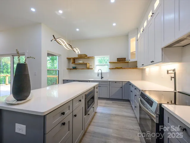 a kitchen with a sink stove and cabinets