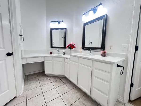 a bathroom with a bathtub a sink and a mirror