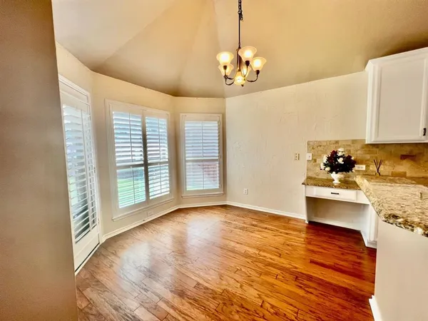 a kitchen with granite countertop a sink stove and cabinets