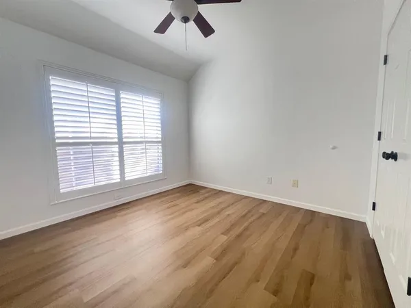 a view of a room with wooden floor and staircase