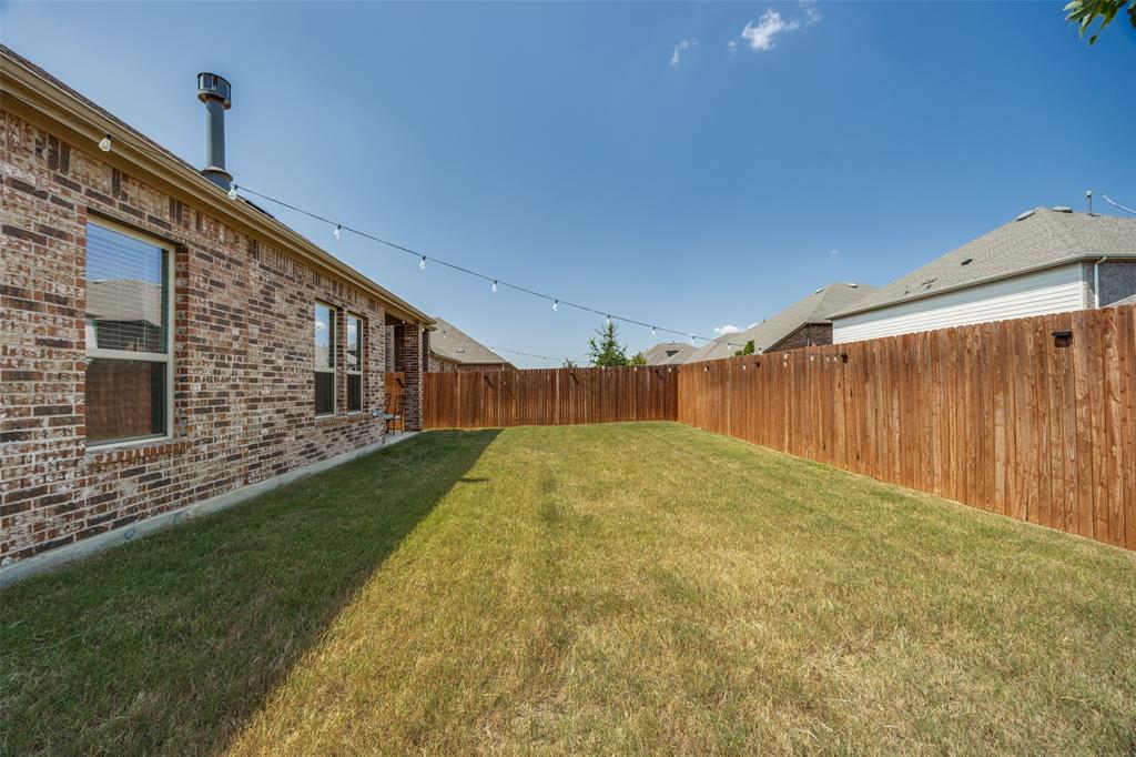 3816 Blacksmith Road Aubrey, TX 76227 - Photo 23 of 30 Expansive grassy backyard featuring a full privacy fence and a brick exterior