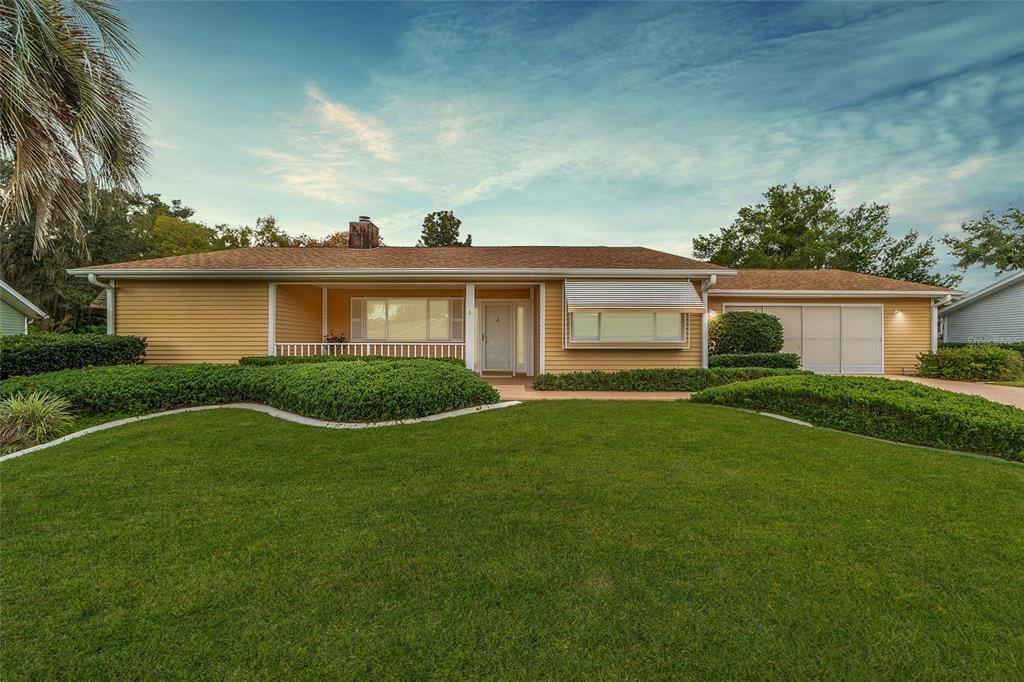 a view of a house with a backyard