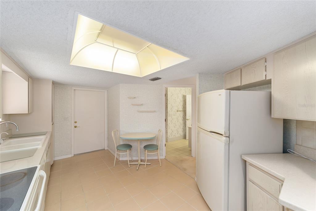 10984 Southwest 82nd Terrace Ocala, FL 34481 - Photo 15 of 40 a white refrigerator freezer sitting in a kitchen