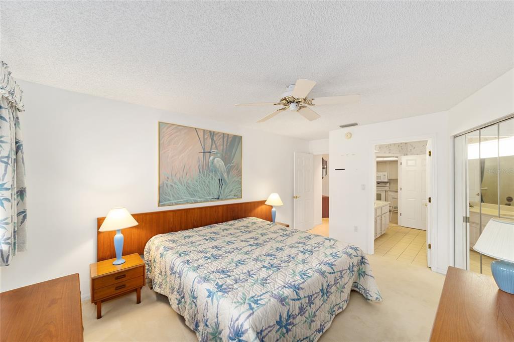 10984 Southwest 82nd Terrace Ocala, FL 34481 - Photo 23 of 40 a bedroom with a large bed and a chandelier