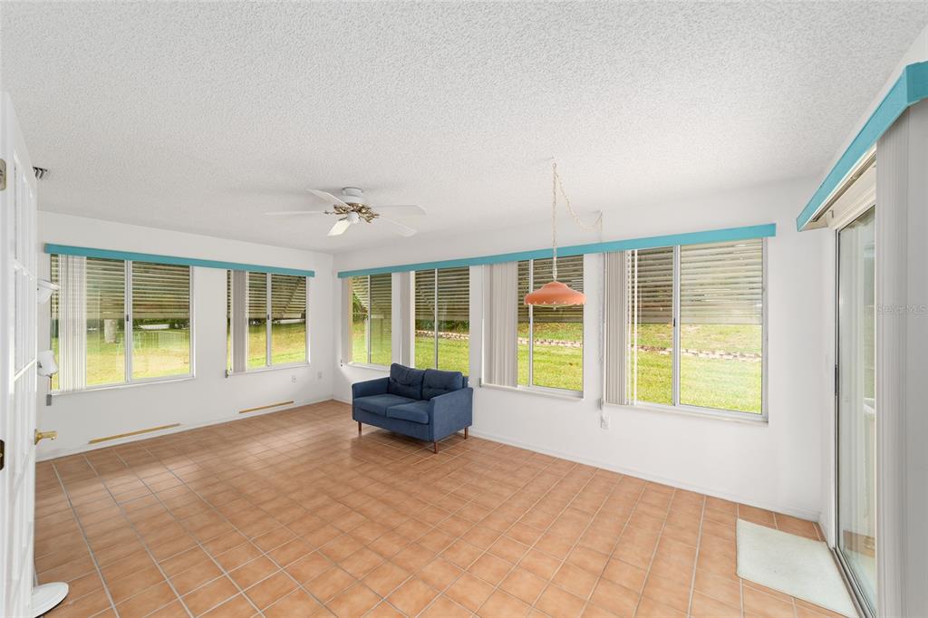 10984 Southwest 82nd Terrace Ocala, FL 34481 - Photo 29 of 40 a view of an empty room with wooden floor and windows