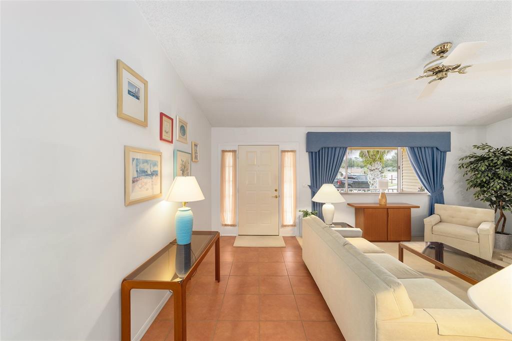 10984 Southwest 82nd Terrace Ocala, FL 34481 - Photo 3 of 40 a living room with furniture and a large window