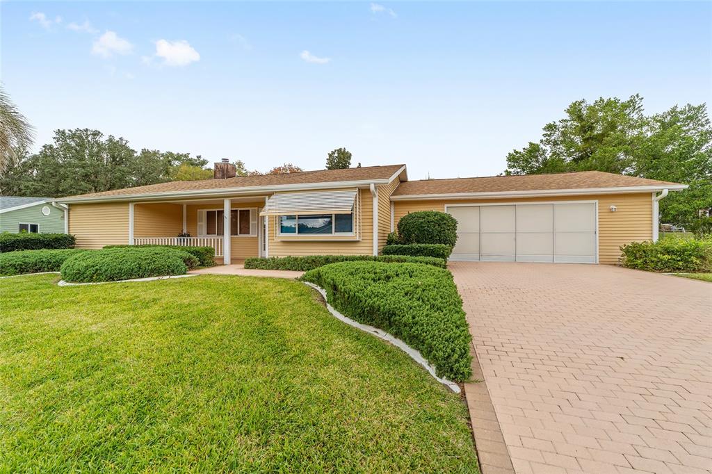 10984 Southwest 82nd Terrace Ocala, FL 34481 - Photo 39 of 40 a front view of a house with a yard and garage