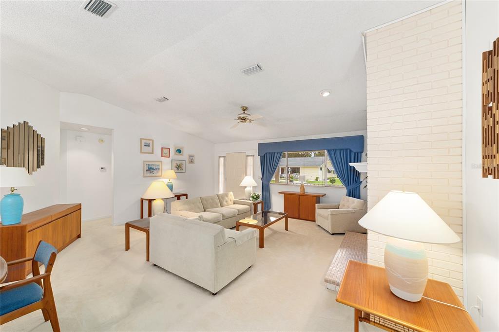 10984 Southwest 82nd Terrace Ocala, FL 34481 - Photo 6 of 40 a living room with furniture and a large window