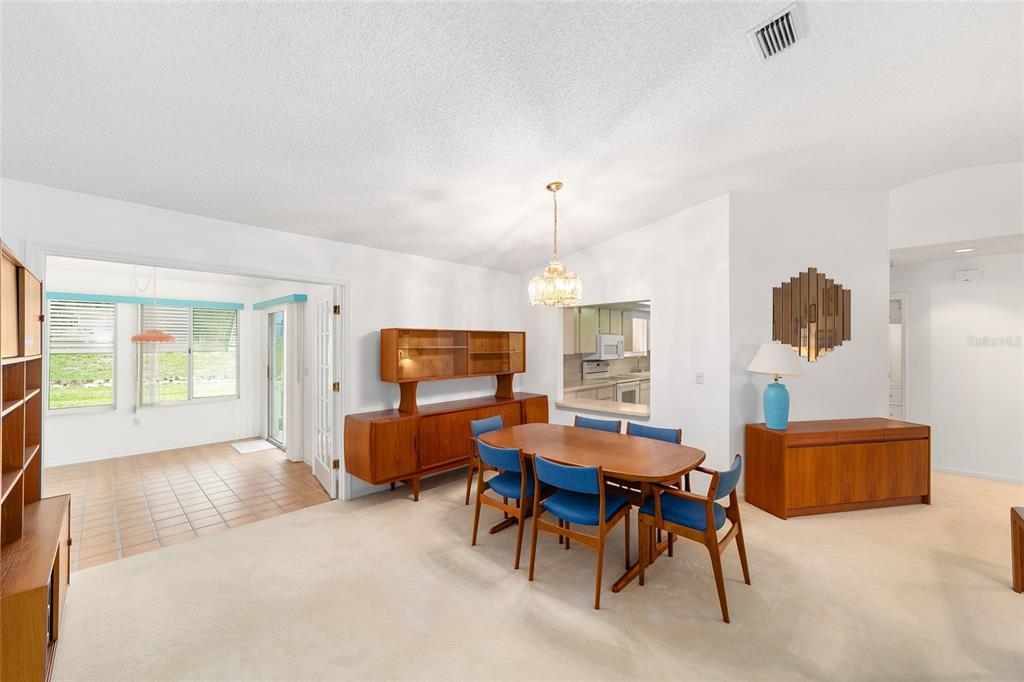 10984 Southwest 82nd Terrace Ocala, FL 34481 - Photo 8 of 40 a living room with furniture a fireplace and a flat screen tv