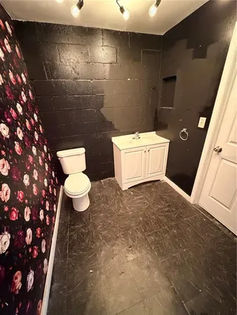 a bathroom with a sink a toilet and a shower
