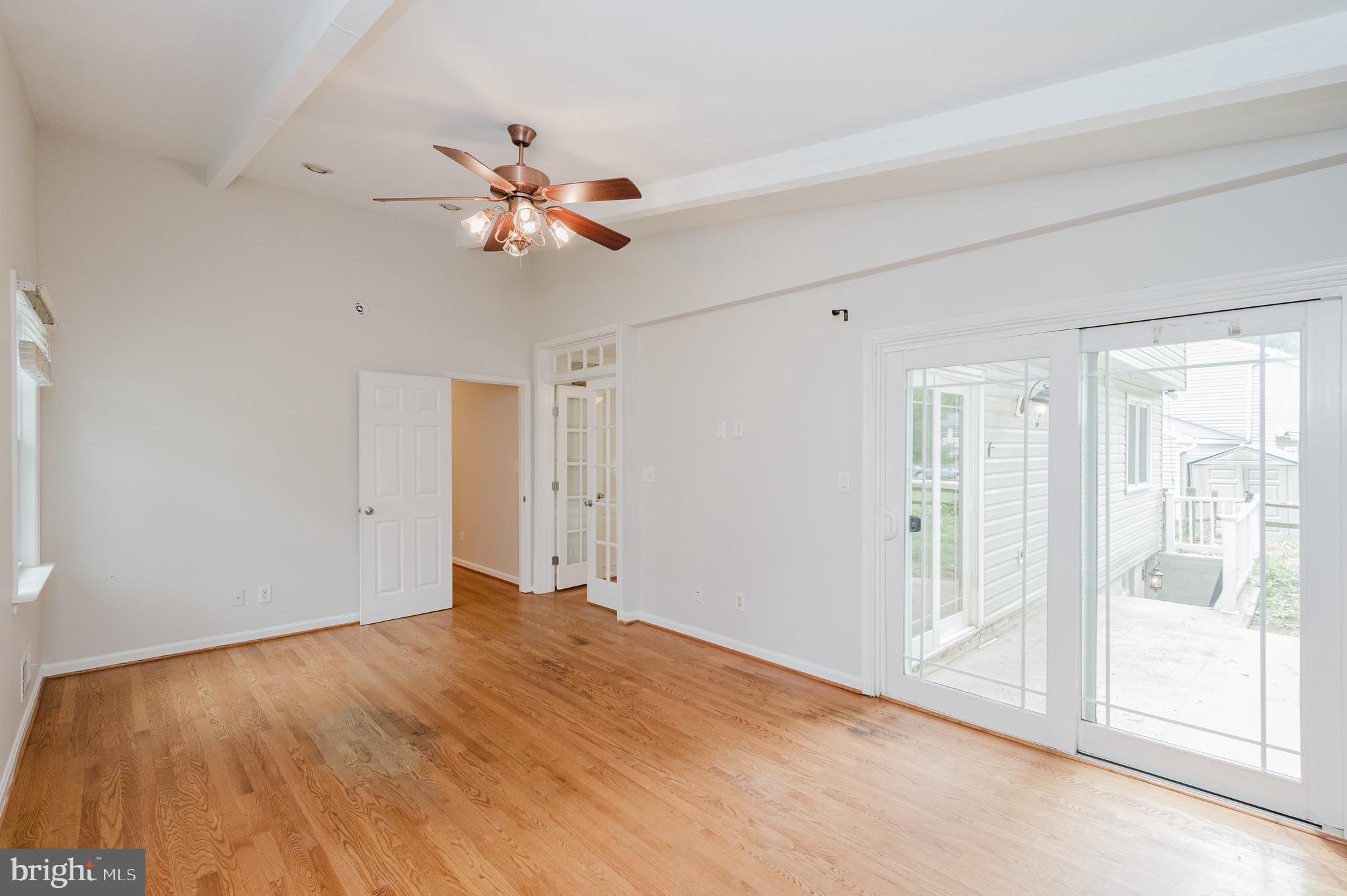 4 Old Spring Court Cockeysville, MD 21030 - Photo 20 of 53 a view of empty room with wooden floor and fan