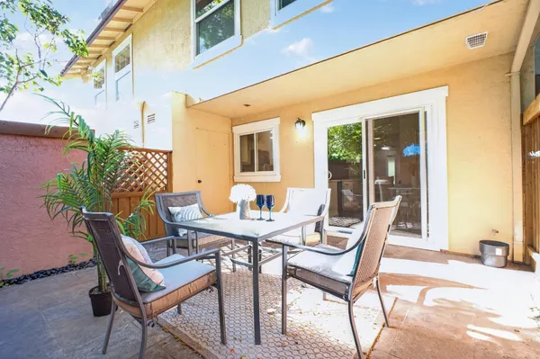 a view of a patio with table and chairs and potted plants
