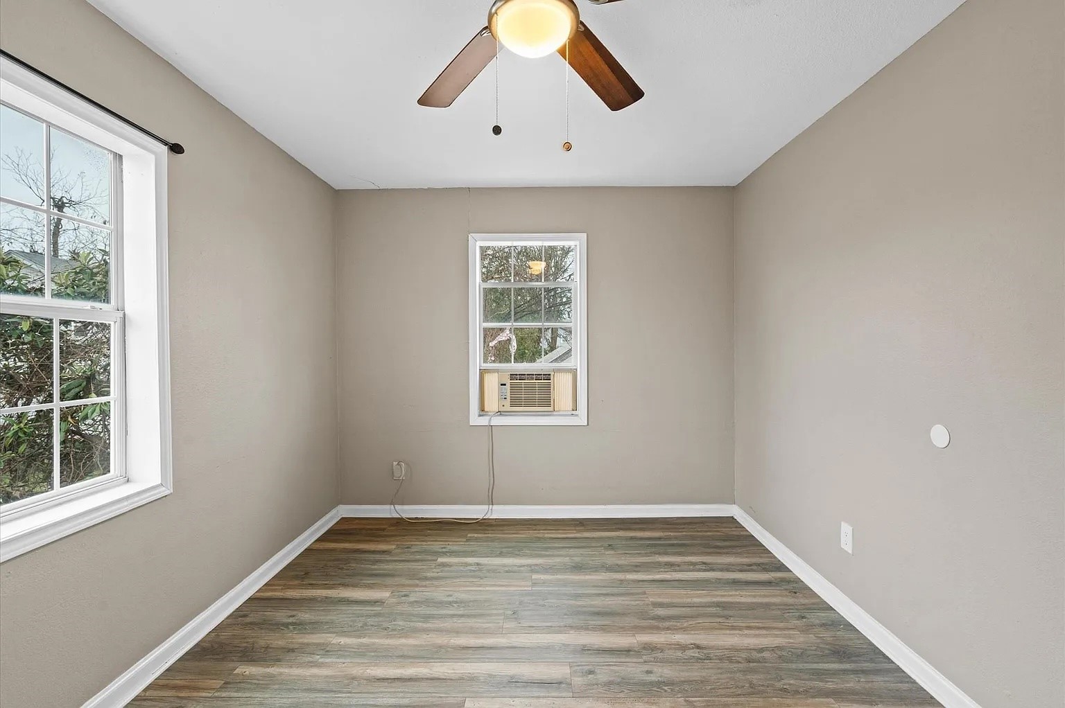 5244 Leeland Street, Unit C Houston, TX 77023 - Photo 2 of 10 a view of empty room with wooden floor and fan