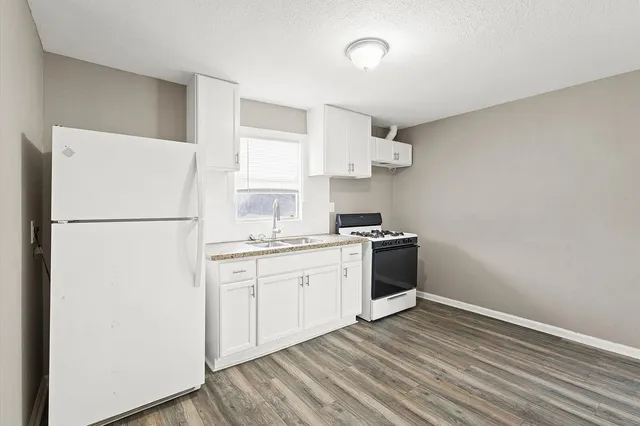 a kitchen with stainless steel appliances a refrigerator sink and cabinets