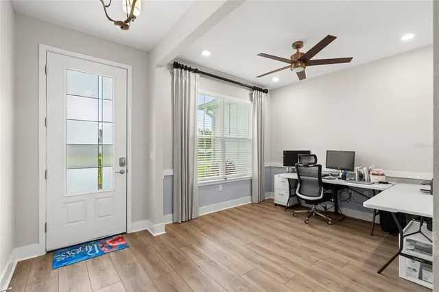 a view of a workspace with furniture and a window