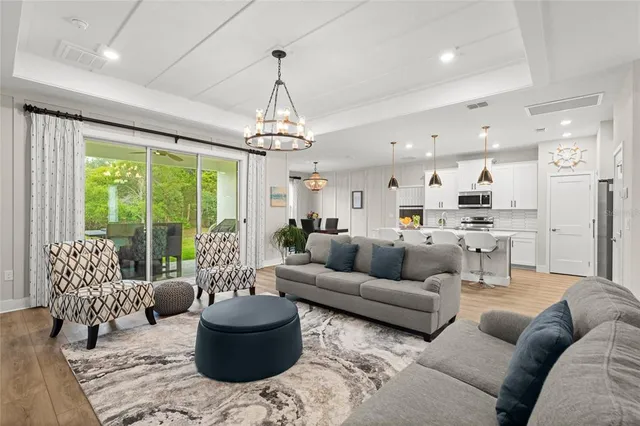 a living room with furniture and a chandelier