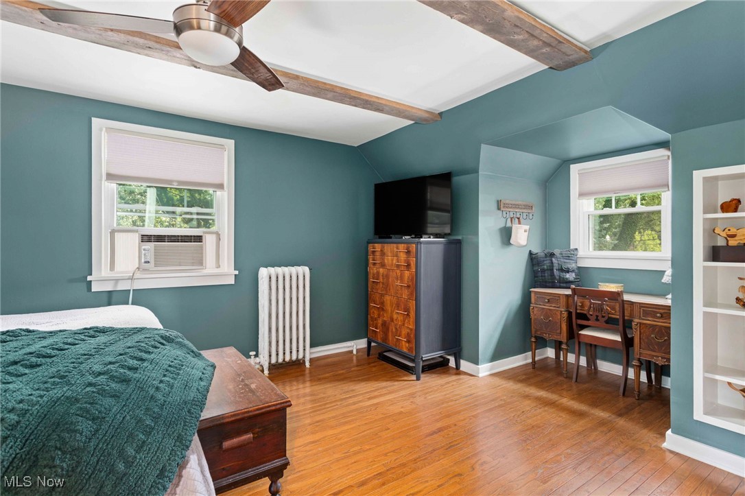 22250 Mastick Road Cleveland, OH 44126 - Photo 22 of 40 Bedroom with beam ceiling, radiator heating unit, wood finished floors, multiple windows, and ceiling fan
