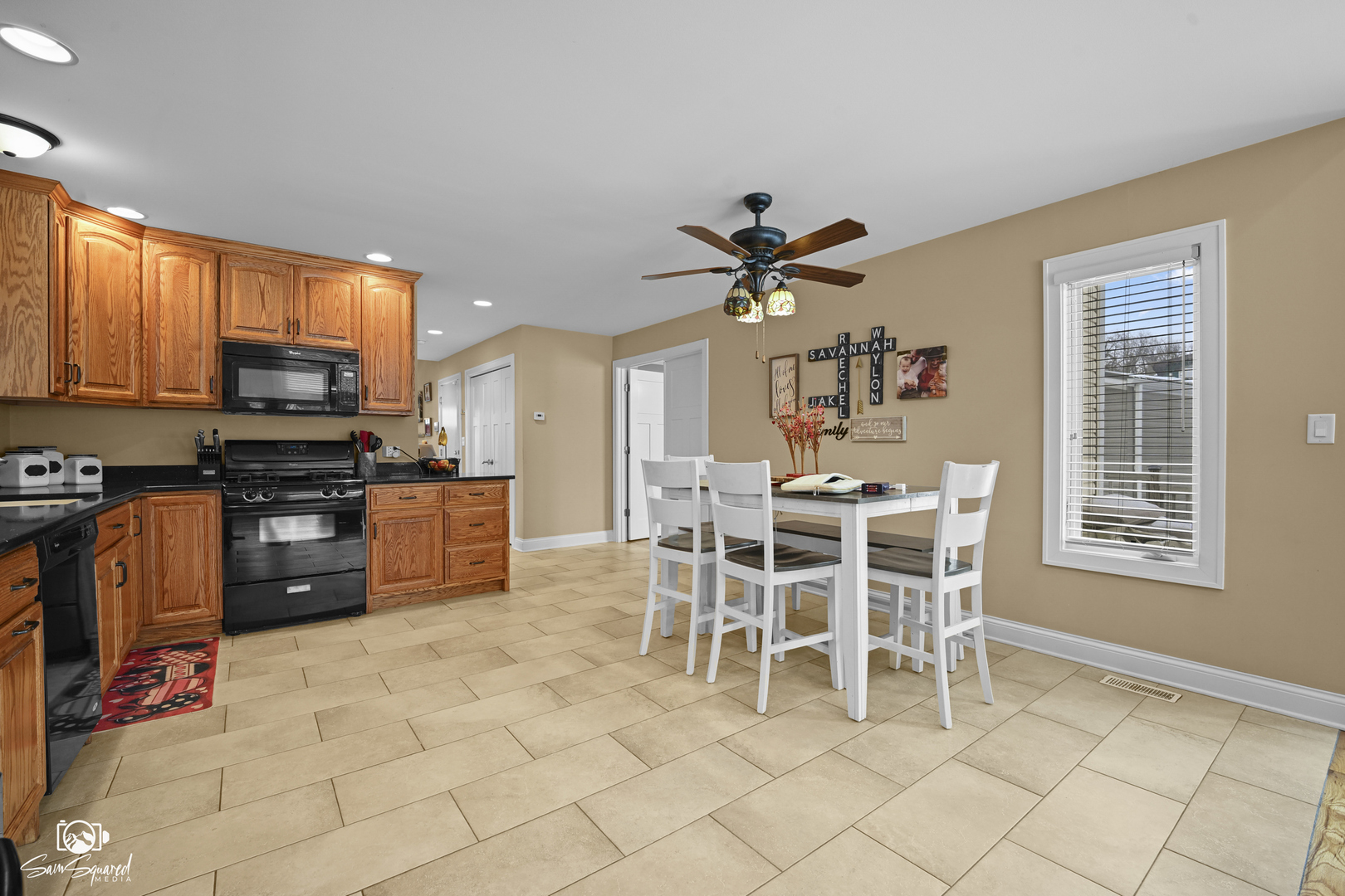 32 Largemouth Lane Wilmington, IL 60481 - Photo 17 of 45 a kitchen with stainless steel appliances kitchen island granite countertop a stove a sink a dining table and chairs with wooden floor