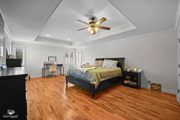 a bedroom with a bed and a chandelier