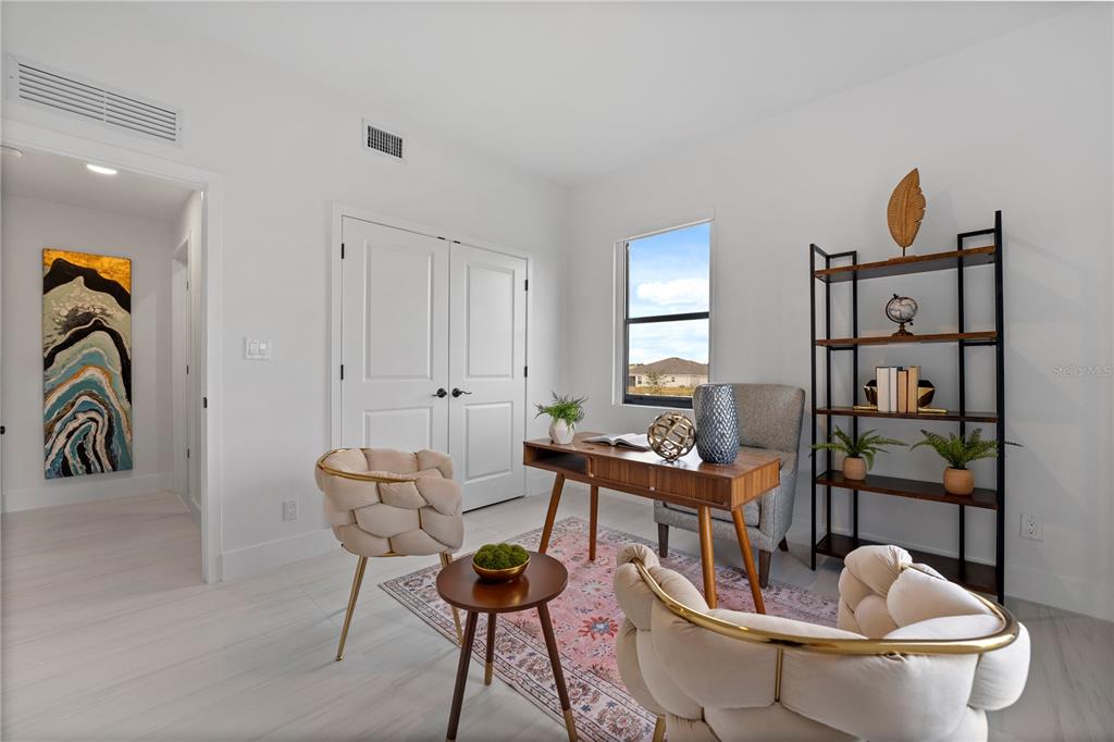 6308 Chorus Drive Mascotte, FL 34753 - Photo 15 of 24 a work room with furniture and wooden floor