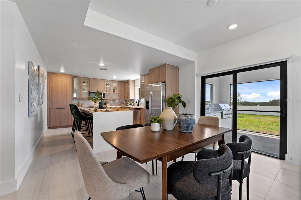 6308 Chorus Drive Mascotte, FL 34753 - Photo 3 of 24 a view of a dining room with furniture and a potted plant