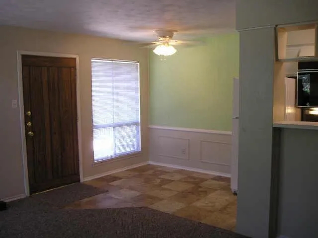 an empty room with windows and closet