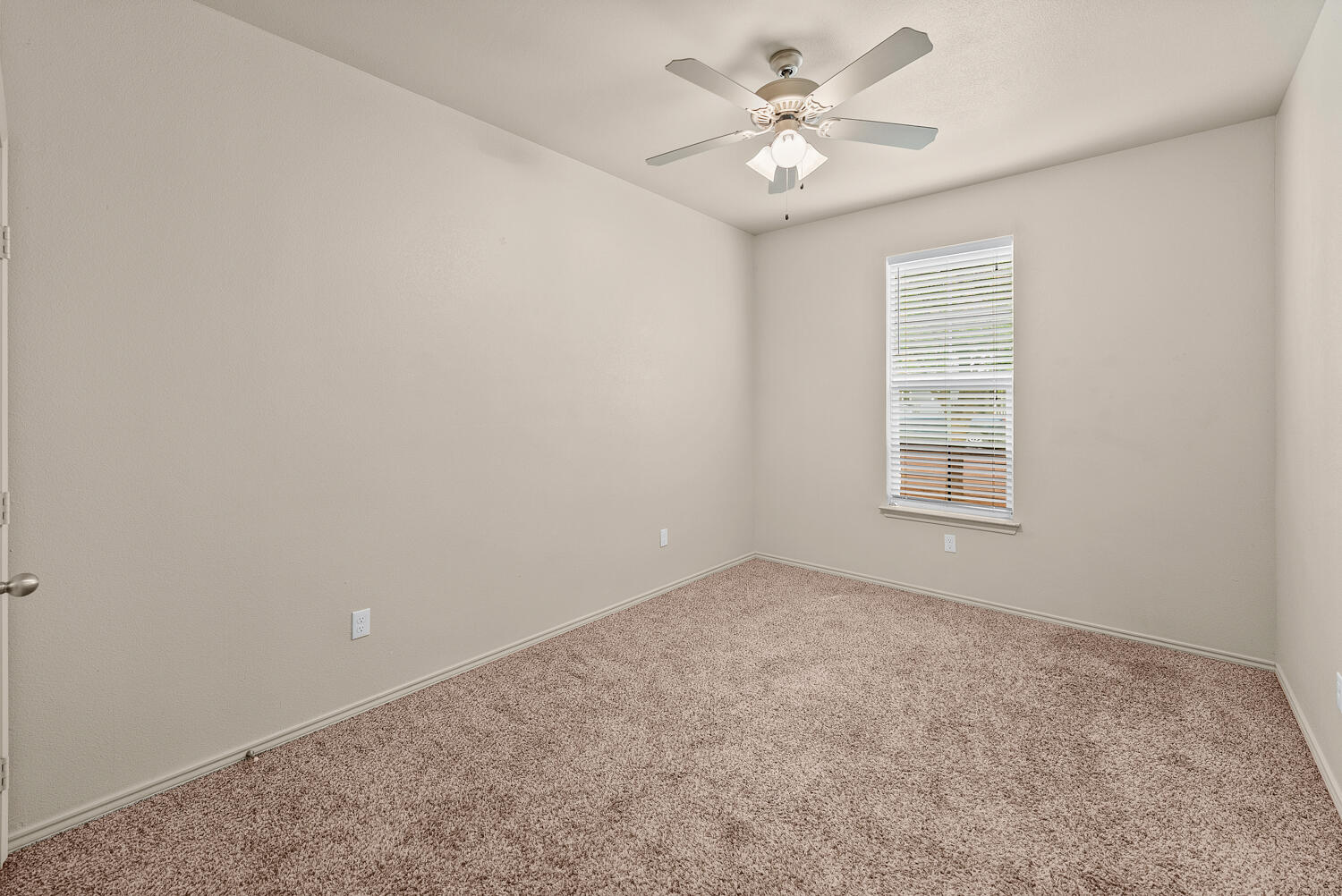 2128 10th Street Lubbock, TX 79401 - Photo 11 of 23 an empty room with windows and ceiling fan
