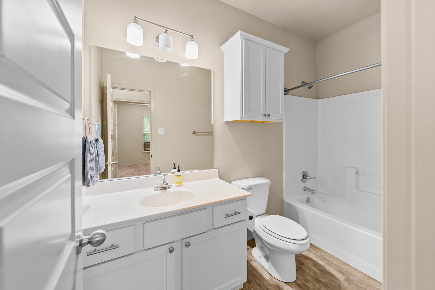 2128 10th Street Lubbock, TX 79401 - Photo 13 of 23 a bathroom with a sink a toilet and shower
