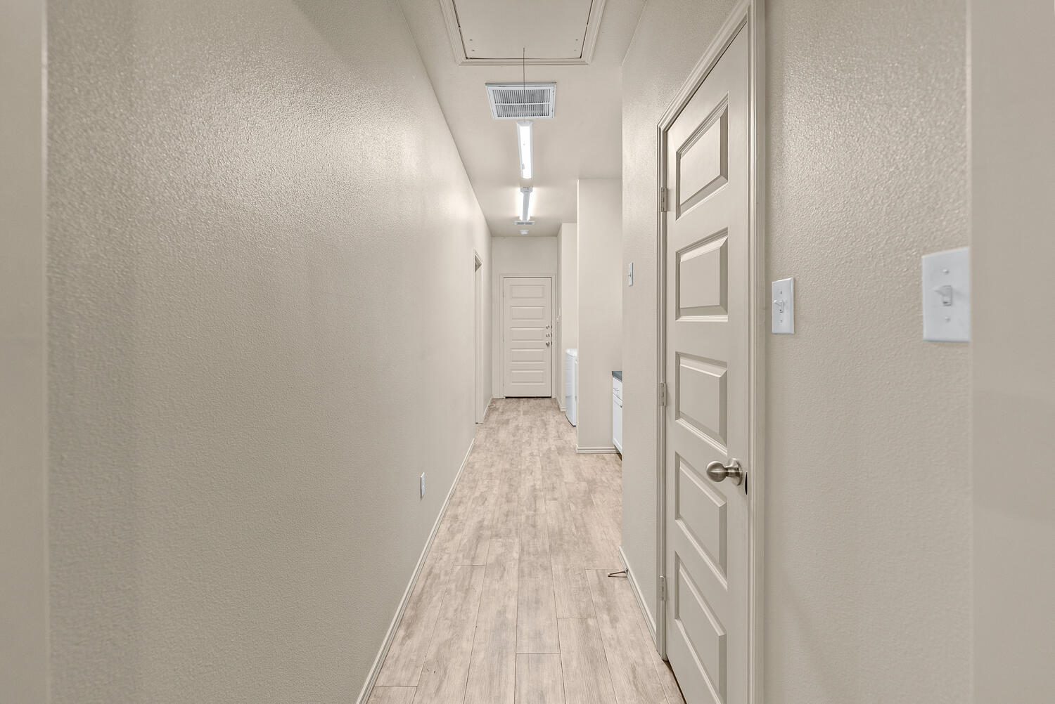 2128 10th Street Lubbock, TX 79401 - Photo 18 of 23 a view of a hallway with wooden floor and a bathroom