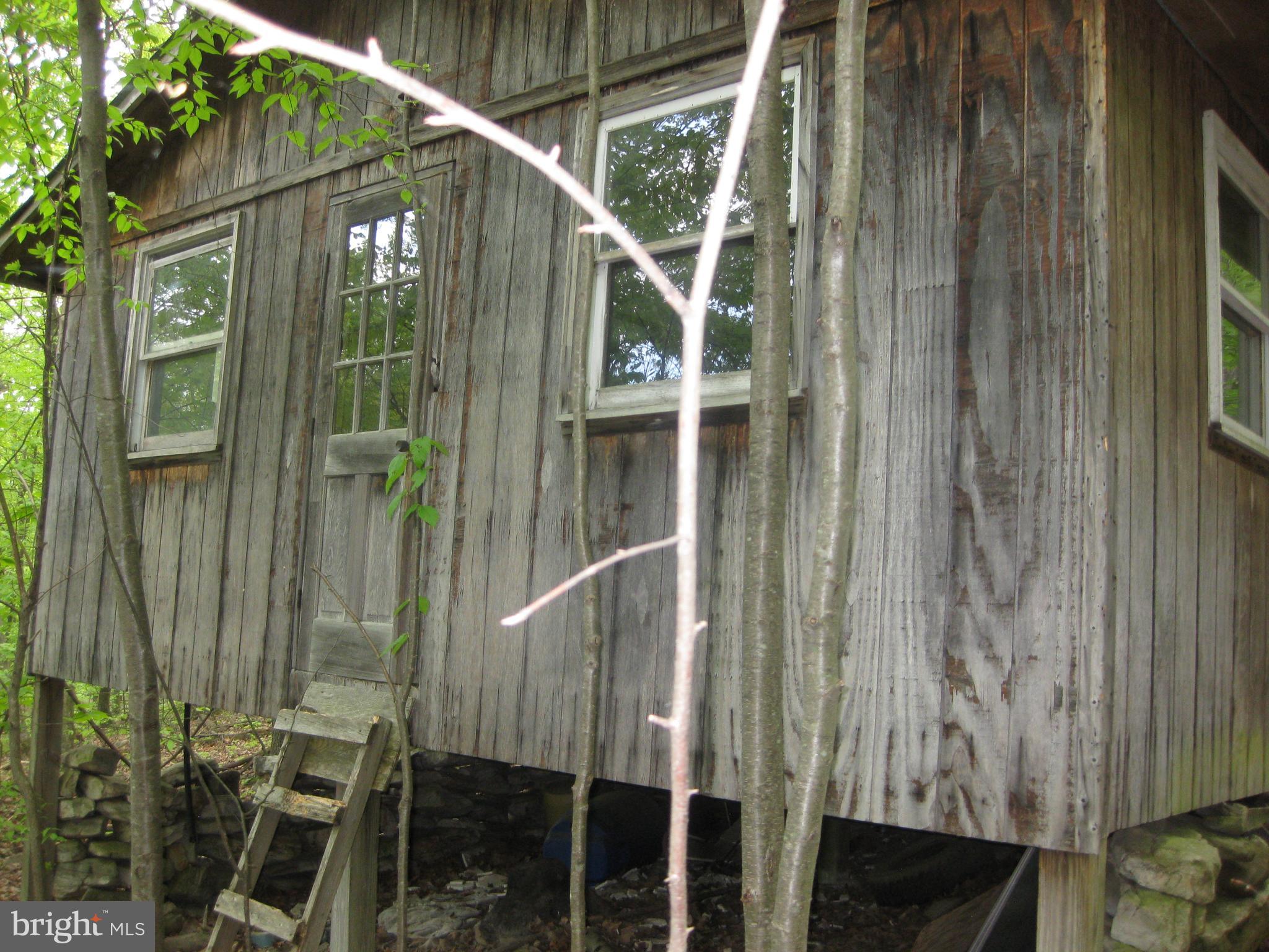 20526 Laurel Mountain Road Three Springs, PA 17264 - Photo 5 of 15 a view of a house with a door and balcony