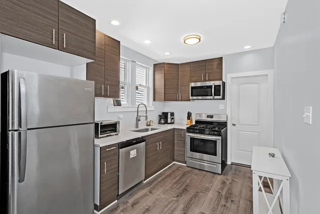 a kitchen with stainless steel appliances a refrigerator stove and microwave