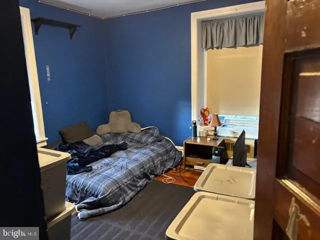 a bed sitting in a bedroom next to a window