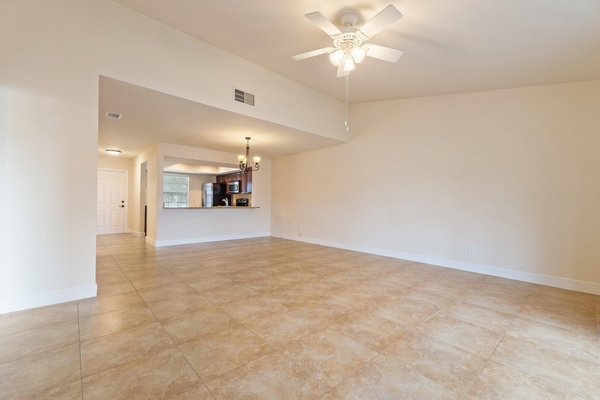109 Doe Trail Jupiter, FL 33458 - Photo 10 of 26 an empty room with a kitchen and a sink