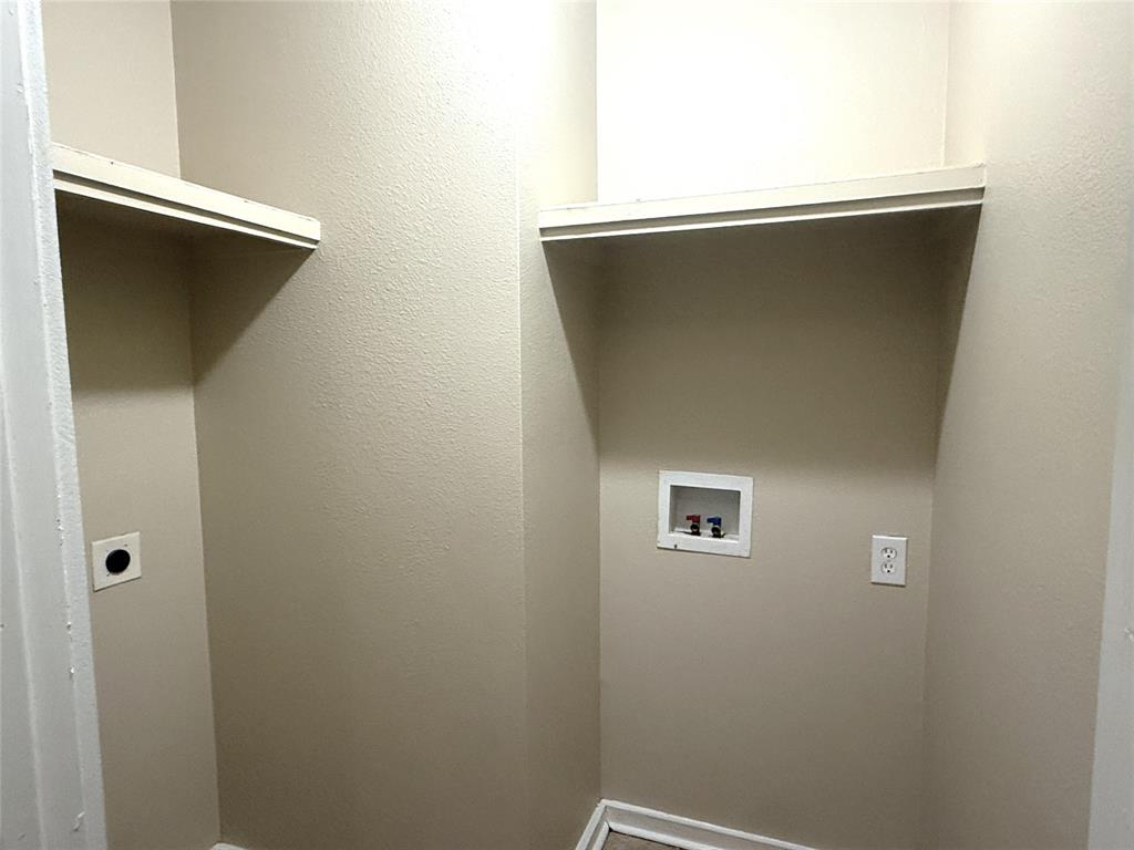 4718 Normandy Road Fort Worth, TX 76103 - Photo 12 of 26 Dedicated laundry area with neutral-toned walls, built-in shelving, and utility hookups for appliances
