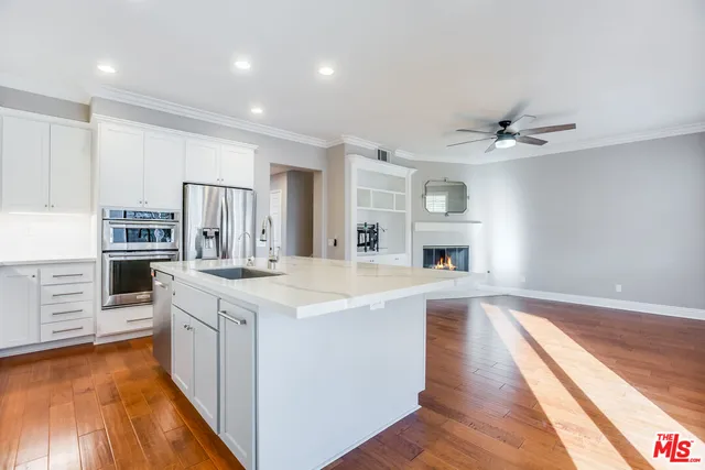 a view of kitchen with sink microwave and refrigerator