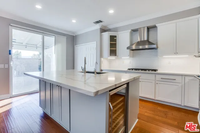 a kitchen with stainless steel appliances granite countertop a sink and a stove