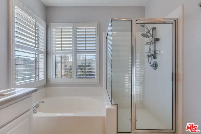 a bathroom with a bathtub and shower