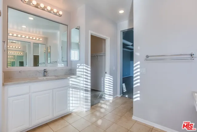 a bathroom with a sink a vanity and a mirror