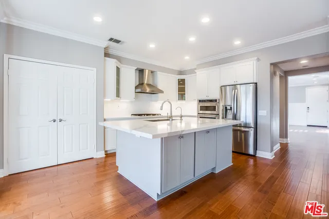 a kitchen with stainless steel appliances granite countertop a refrigerator and a sink
