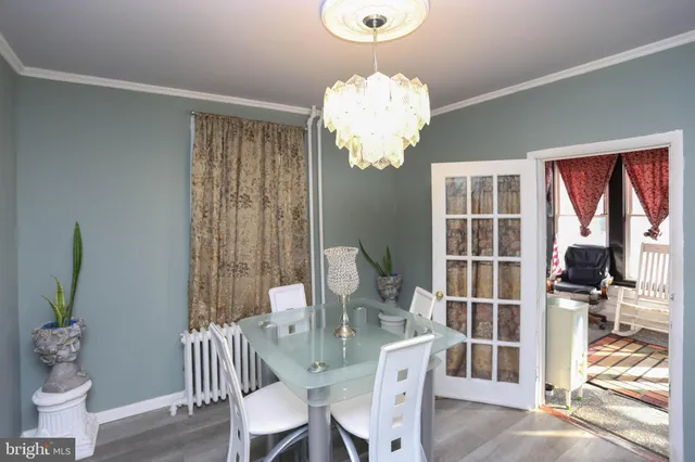 a view of a dining room with furniture wooden floor and chandelier