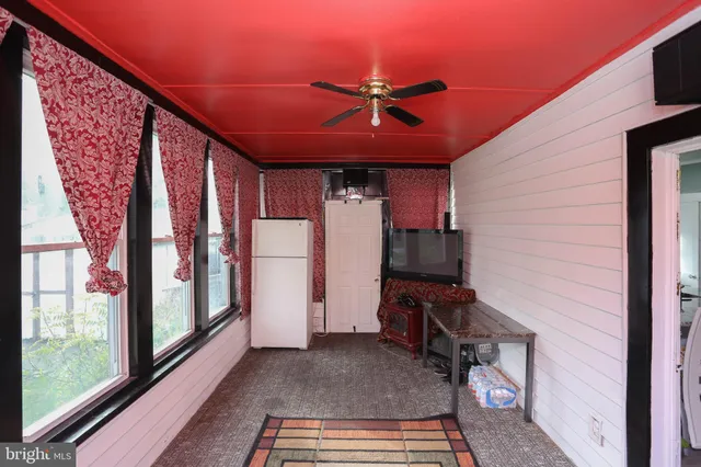 a workspace with wooden floor and windows