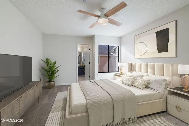 a bedroom with a bed and a potted plant