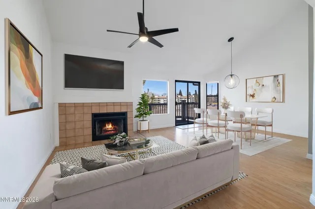 a living room with furniture a flat screen tv and a fireplace