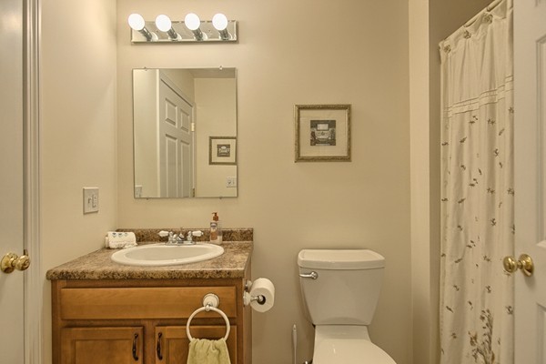 159 Allen Road, Unit 28 Billerica, MA 01821 - Photo 12 of 28 a bathroom with a granite countertop sink a toilet and a mirror