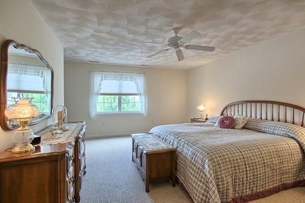 159 Allen Road, Unit 28 Billerica, MA 01821 - Photo 13 of 28 a bedroom with a bed and a chandelier
