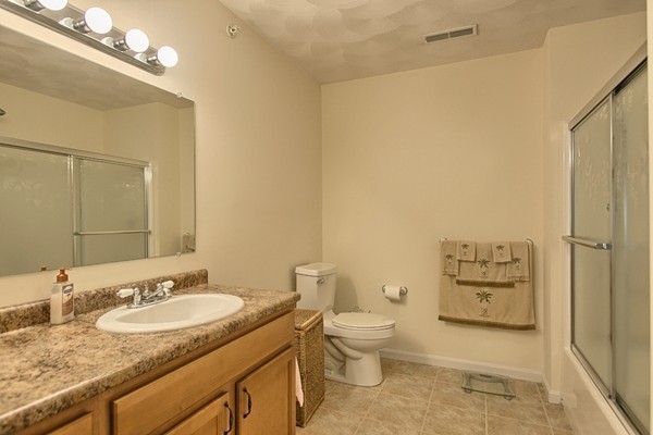 159 Allen Road, Unit 28 Billerica, MA 01821 - Photo 14 of 28 a bathroom with a granite countertop sink mirror vanity and toilet