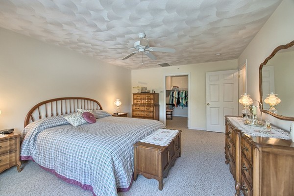 159 Allen Road, Unit 28 Billerica, MA 01821 - Photo 15 of 28 a bedroom with a large bed and a chandelier