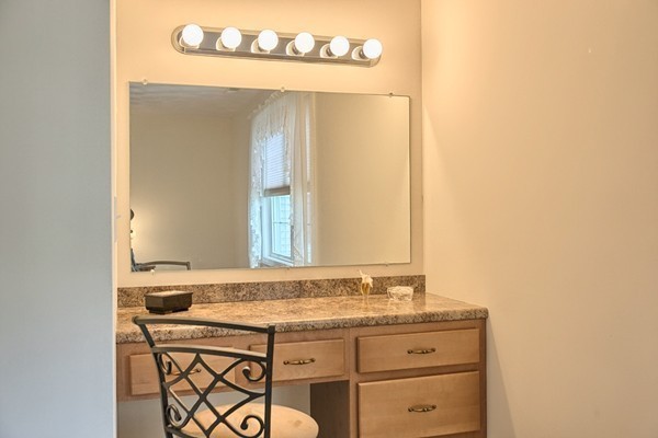 159 Allen Road, Unit 28 Billerica, MA 01821 - Photo 17 of 28 a bathroom with a granite countertop sink and a mirror