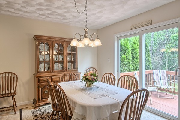 159 Allen Road, Unit 28 Billerica, MA 01821 - Photo 10 of 28 a view of a dining room with furniture a chandelier and wooden floor