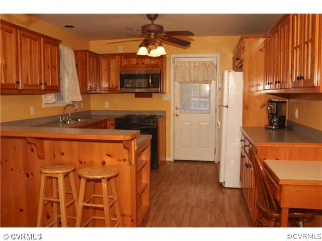 7925 Claystreet Road Ford, VA 23850 - Photo 3 of 13 a kitchen with a sink refrigerator and cabinets